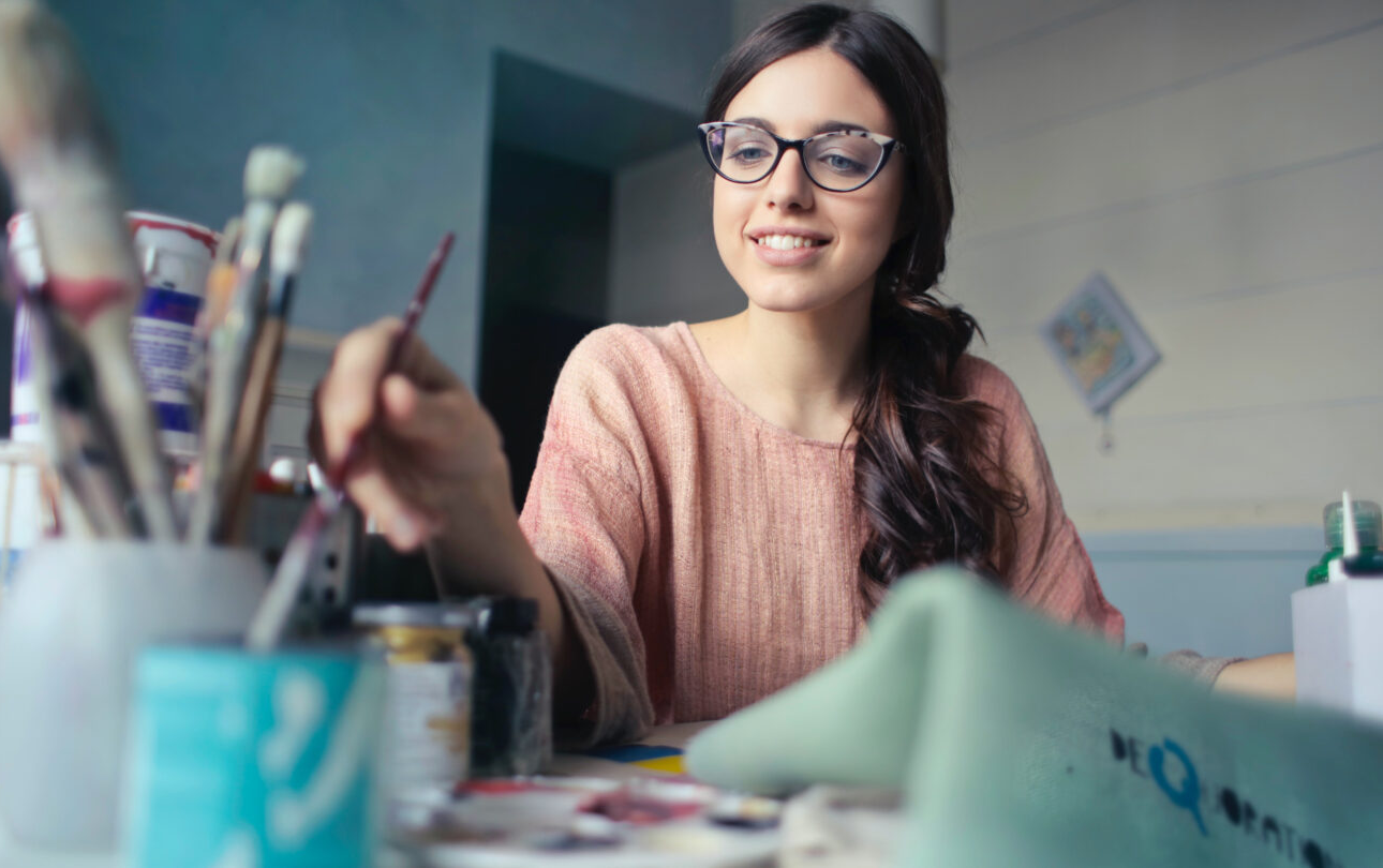 Young woman using art tools