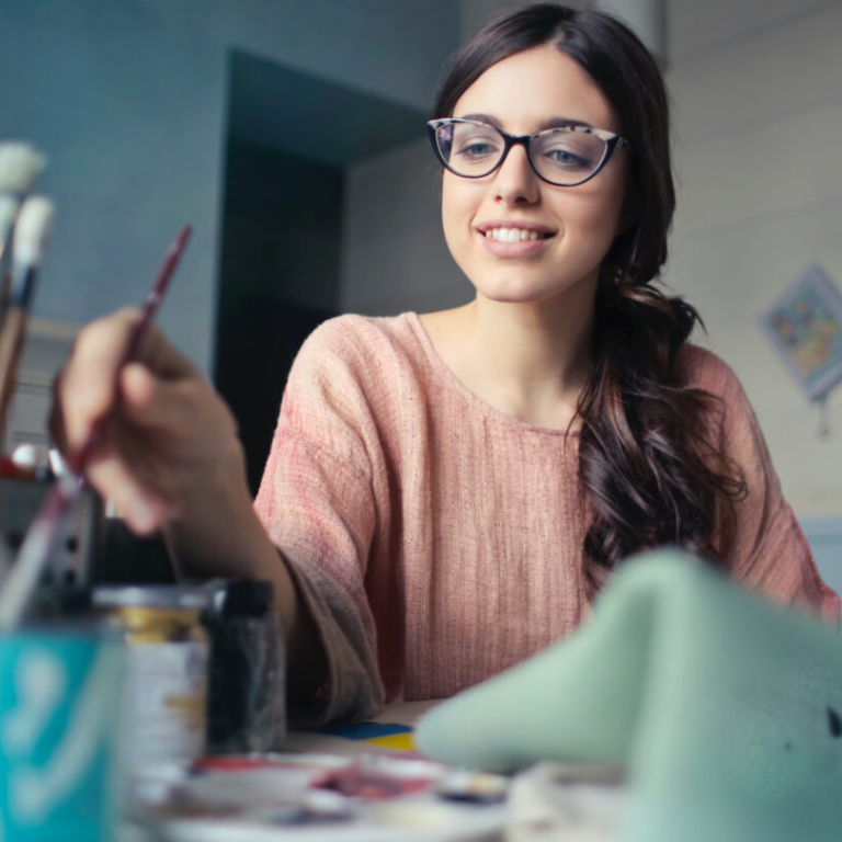 Young woman using art tools