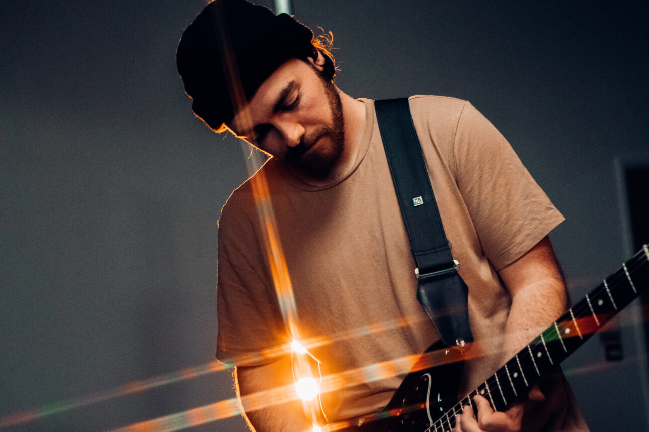 man playing an electric guitar