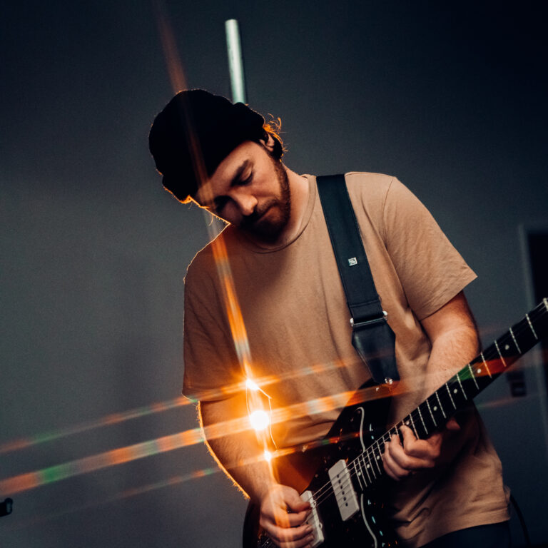 man playing an electric guitar