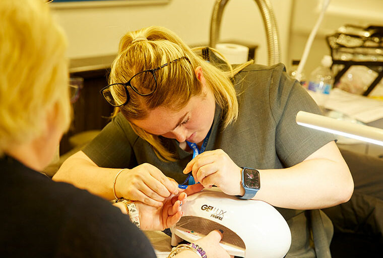 A student working on a client's nails