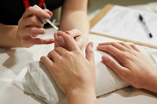 Someone having their finger nails painted