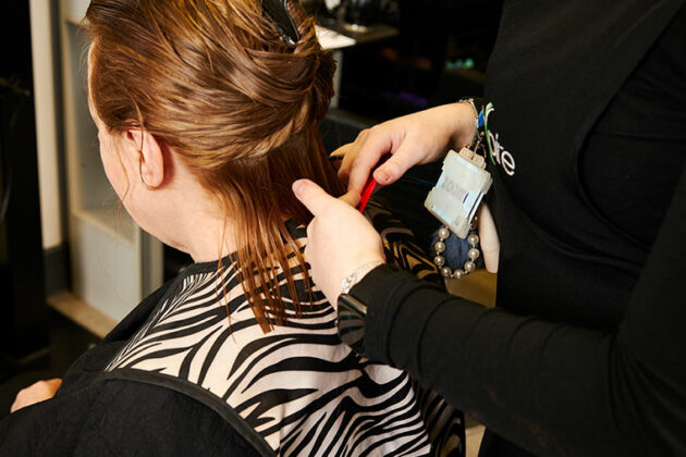 A client having their hair trimmed