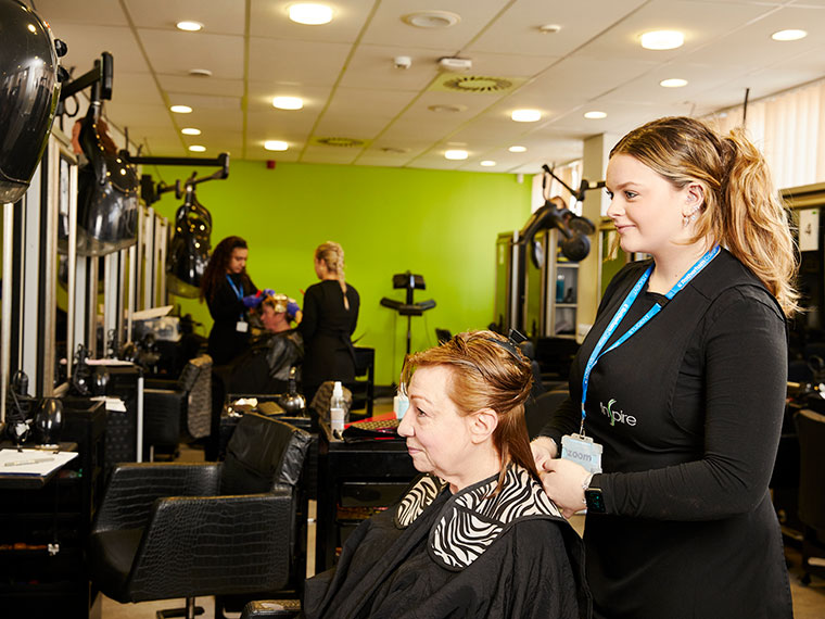A hairdressing student in the salon with a client