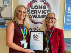 Lucy being awarded her 20 year service award by Jane Hartog